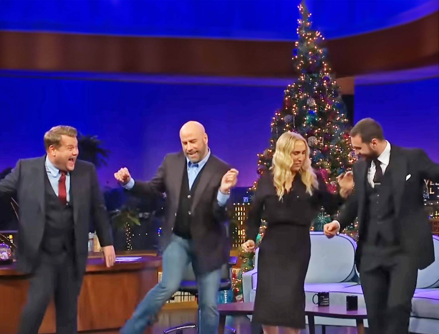 John Travolta shows he’s still got it with cheeky dance lesson for